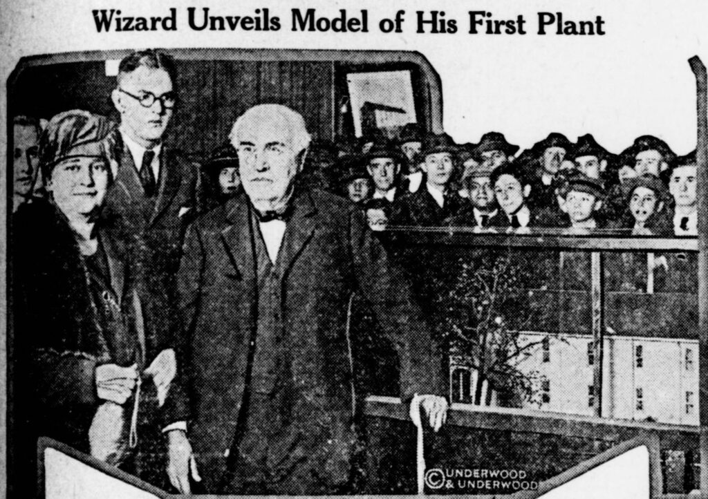 Thomas Edison and his wife standing in front of a model of the first Edison factory at the New York electrical show at Grand Central palace. November 16, 1922. The Herald (New Orleans, LA)